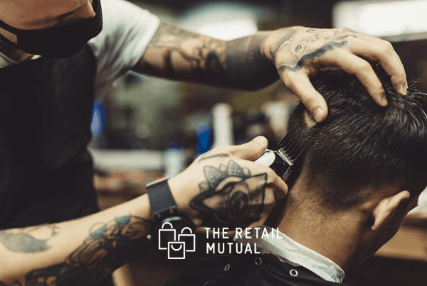 barber giving a cut wearing a face mask